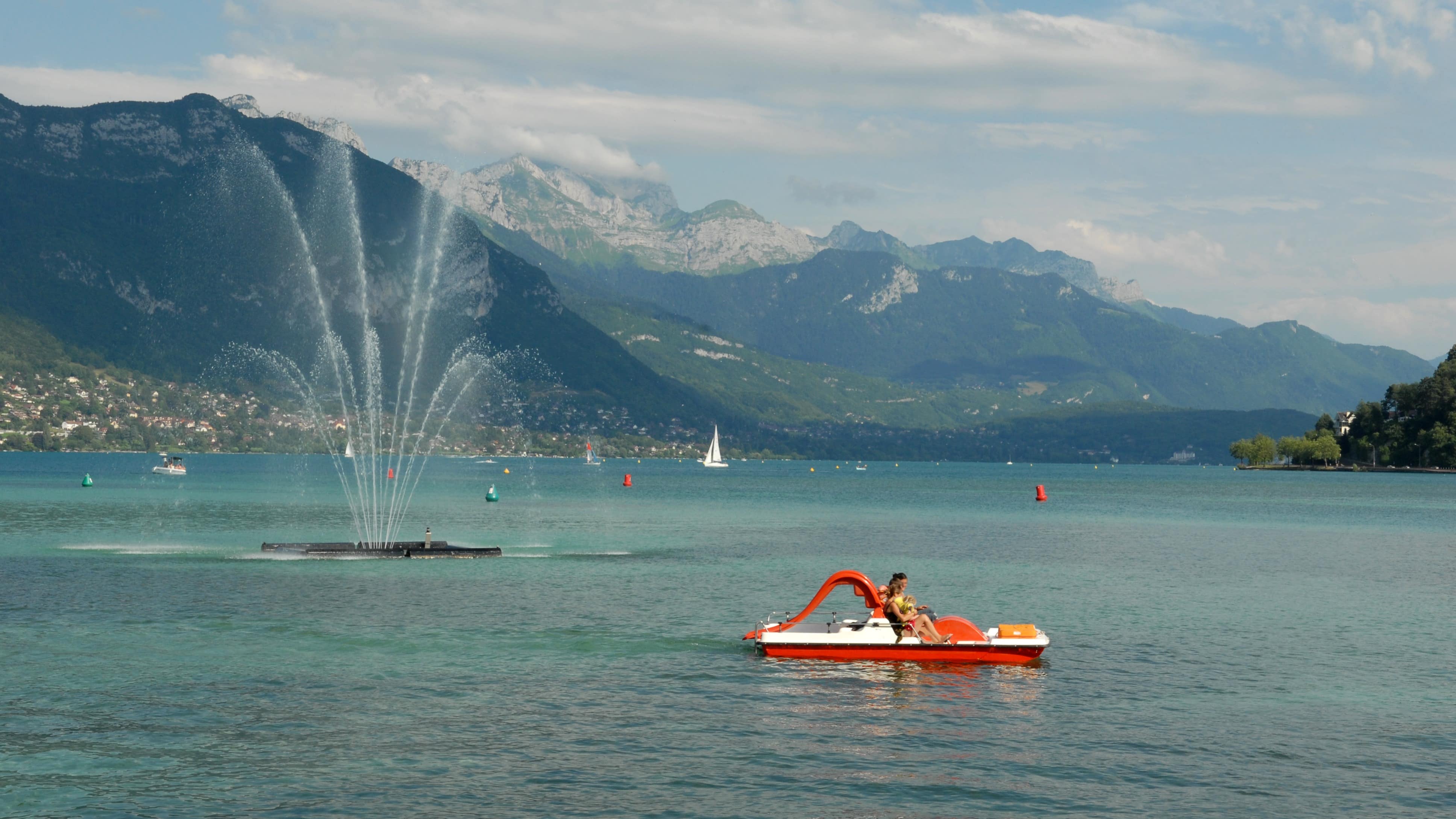 Des personnes en pédalo sur le lac d’Annecy