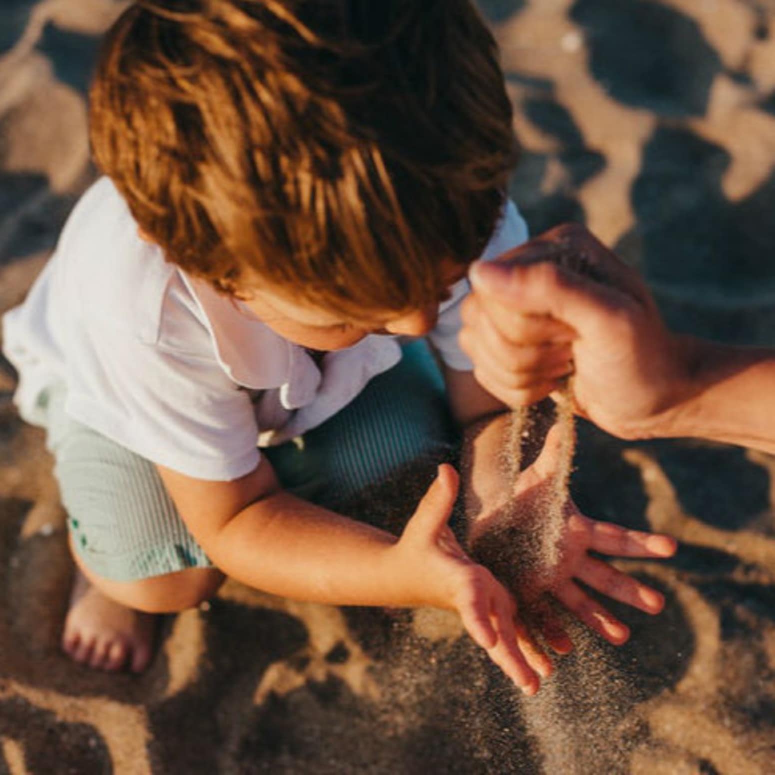Enfant sur la plage jouant avec du sable, séjour famille, location vacances valras plage