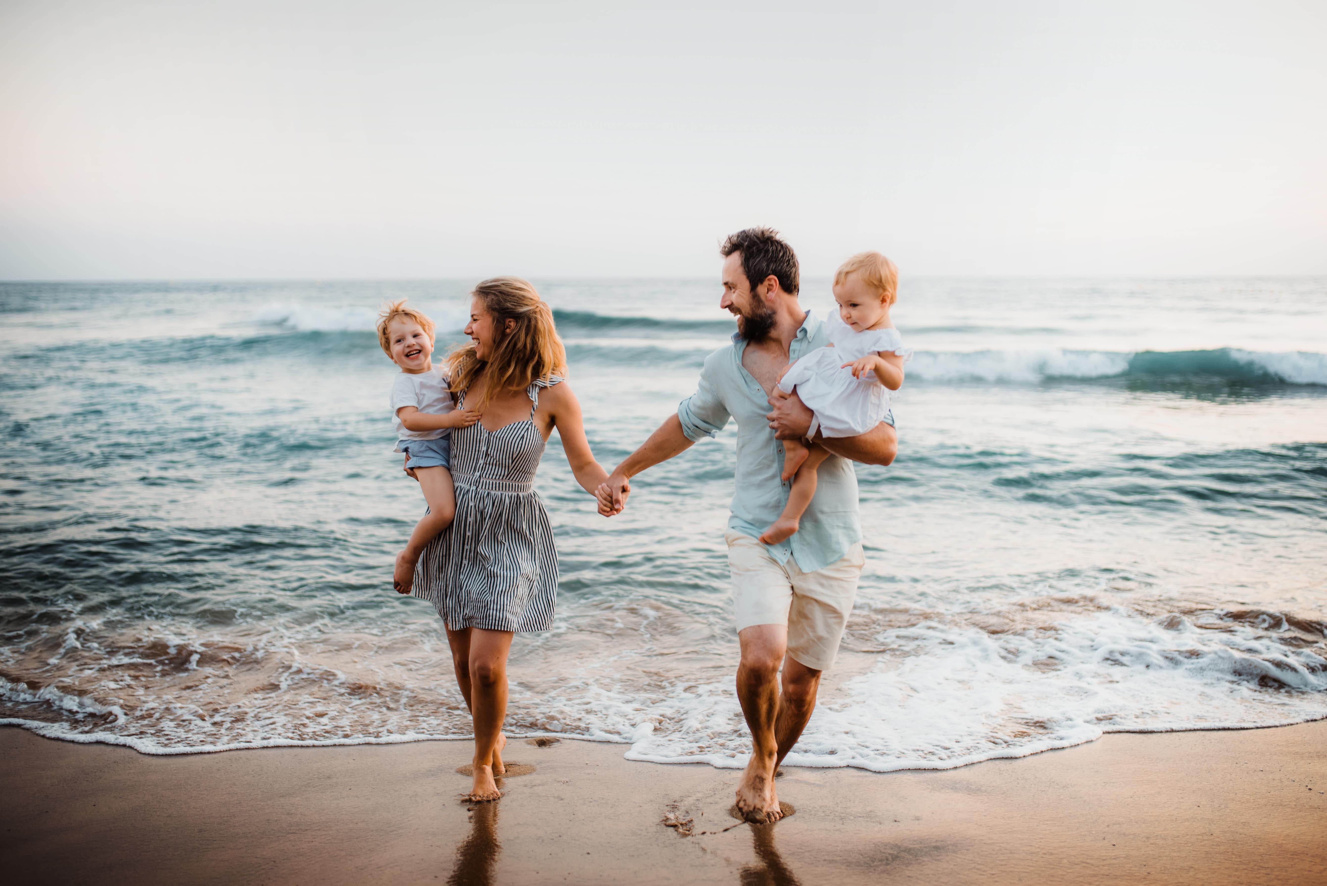 éclaboussures de famille dans l'eau à la plage