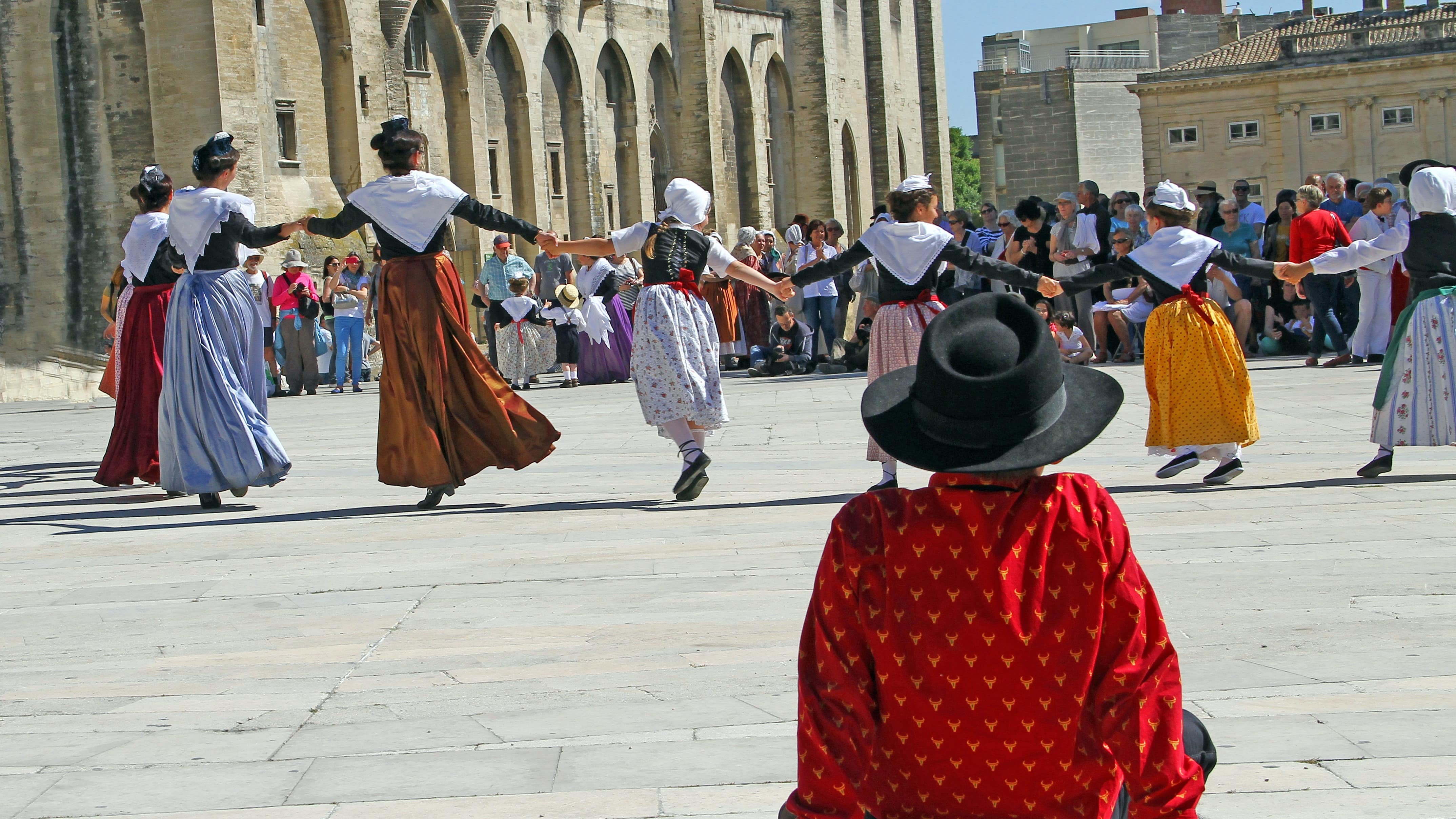 Farandole provençale, avec costumes traditionnels, devant le palais des Papes à Avignon