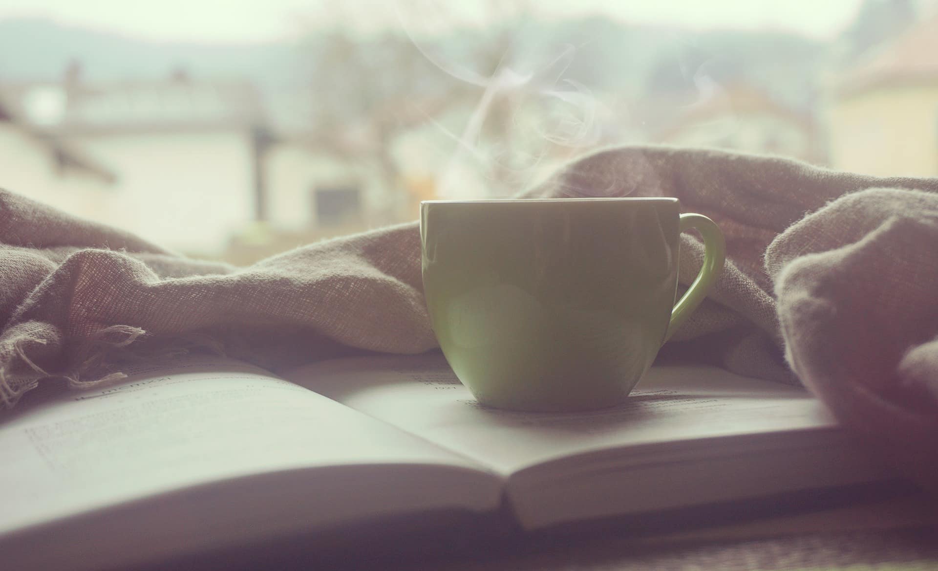Stock image - Cosy cup of coffee and a book - Photo by Andrian Valeanu