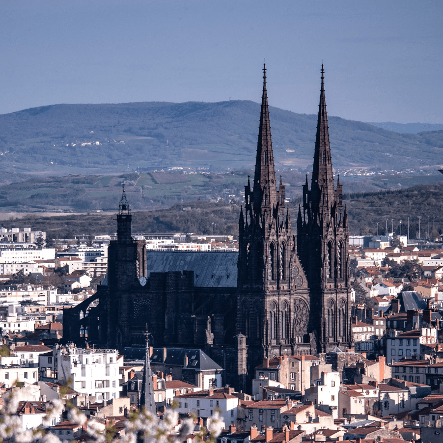 picture of a cathedral with mountains in the background