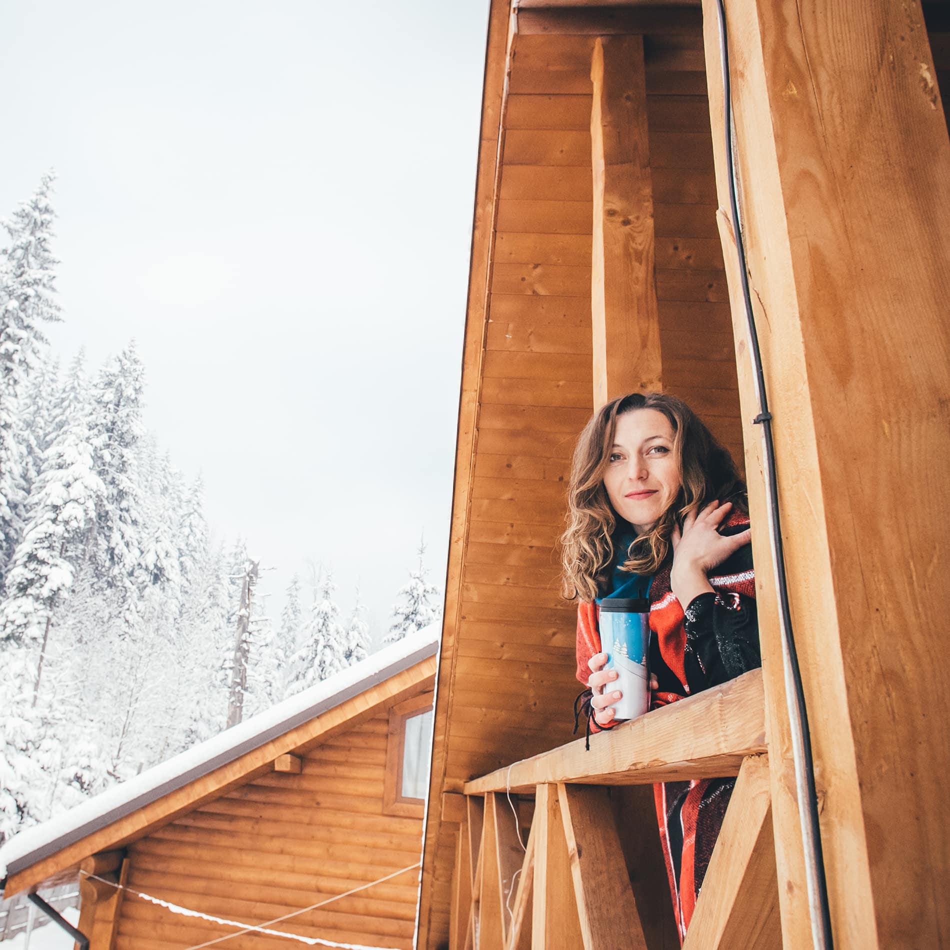 Woman in a cabin in snowy decor