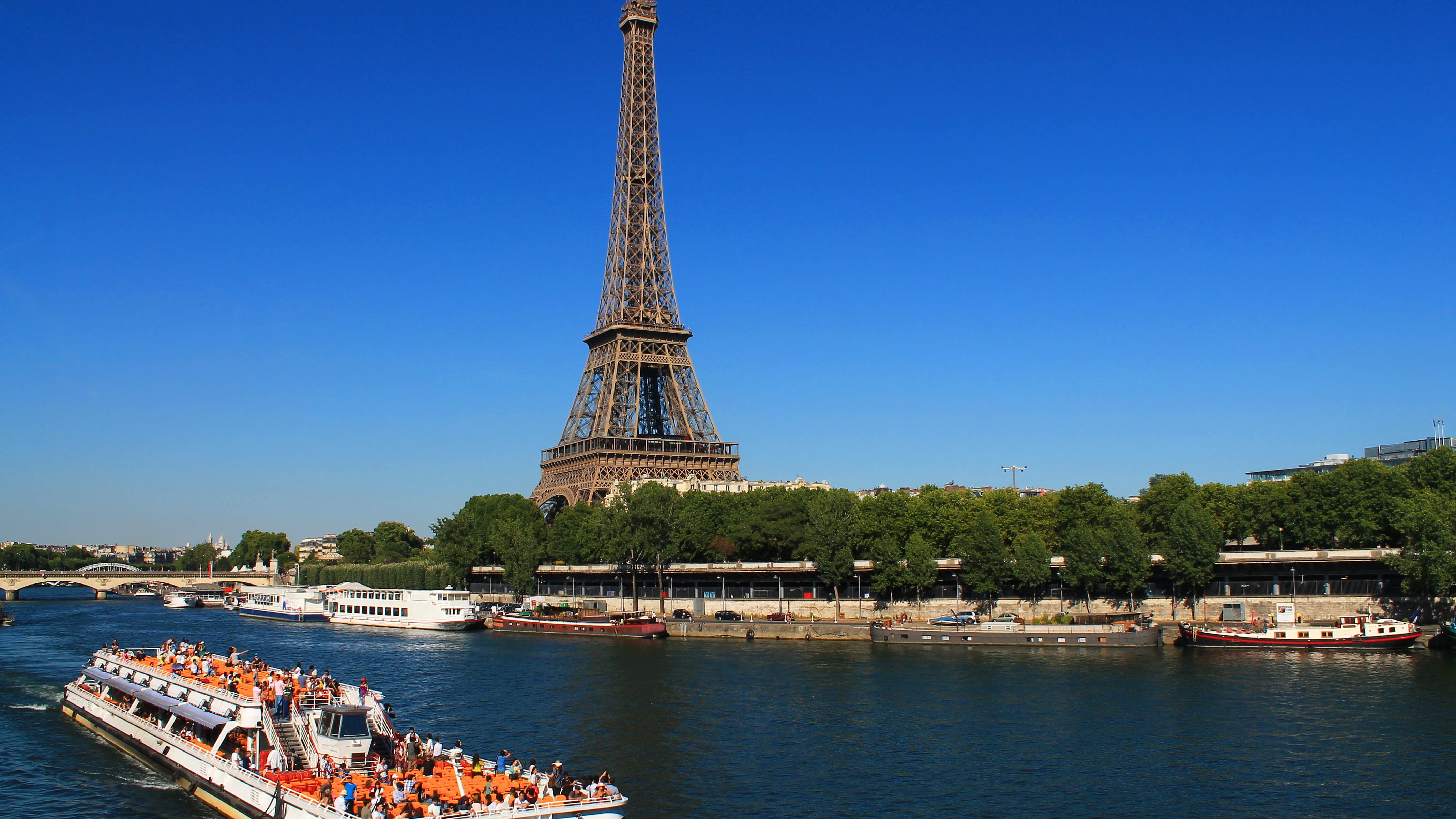 Bateau-mouche qui navigue sur la Seine, devant la tour Eiffel à Paris